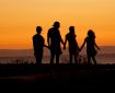 Family holding hands on beach